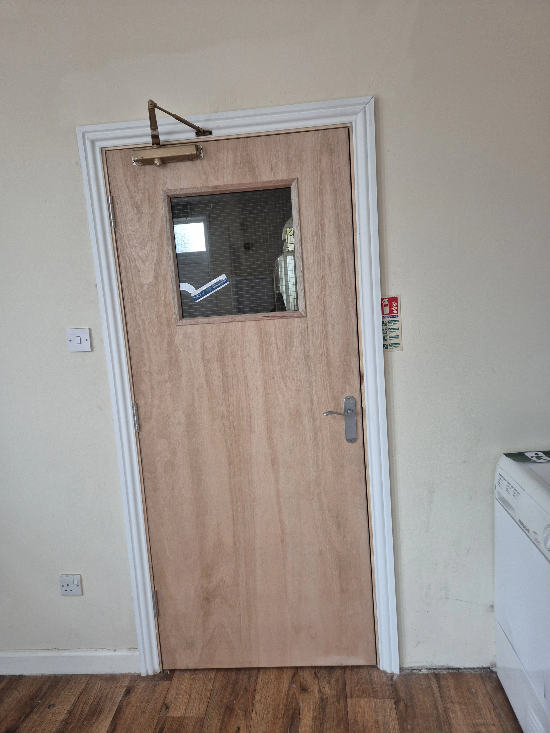 Door with vision panel and closer